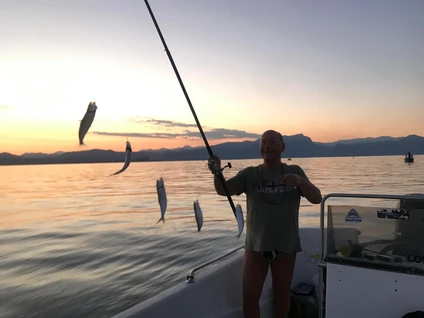 Fishing for sardines from the motorboat on Lake Garda at sunset 0